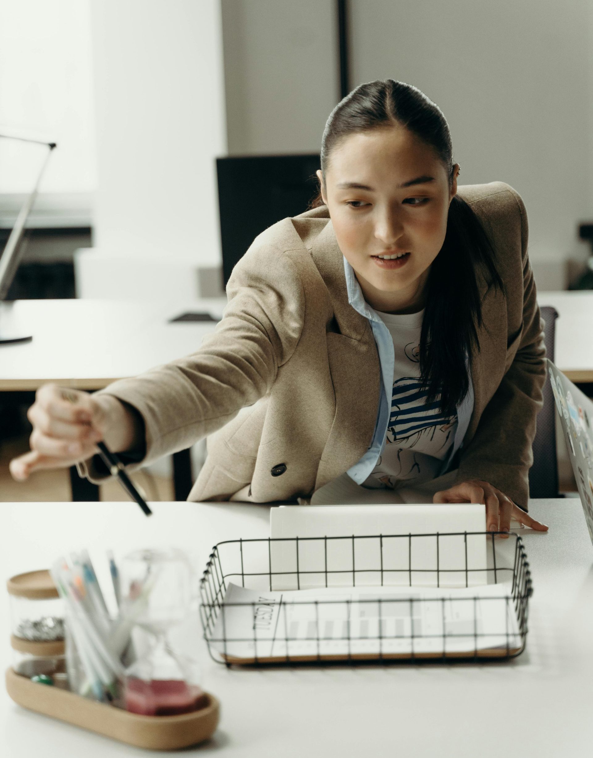 Asian businesswoman planning a project in a modern workplace environment.